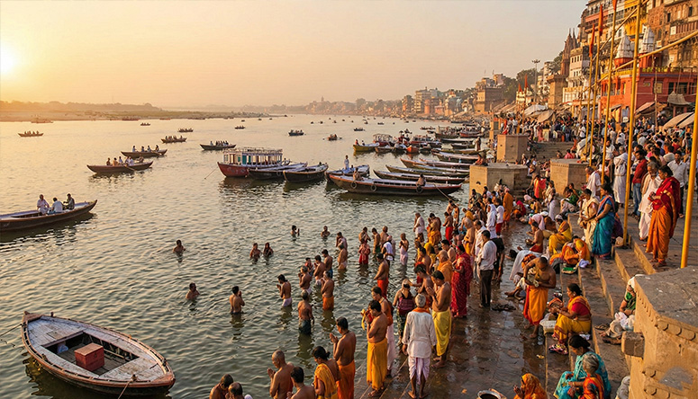View of the Ganges river banks in India with pilgrims and boats illustrating the connection to the Great Mother