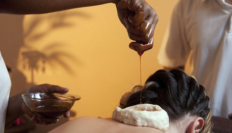 Photo of warm herbal oil pouring into a neck reservoir to relieve tension and cervical osteochondrosis