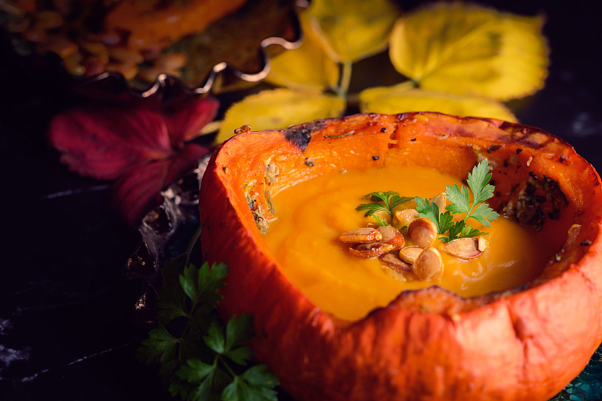 Photo of creamy pumpkin soup with coconut milk swirl demonstrating Vata pacifying autumn recipes.