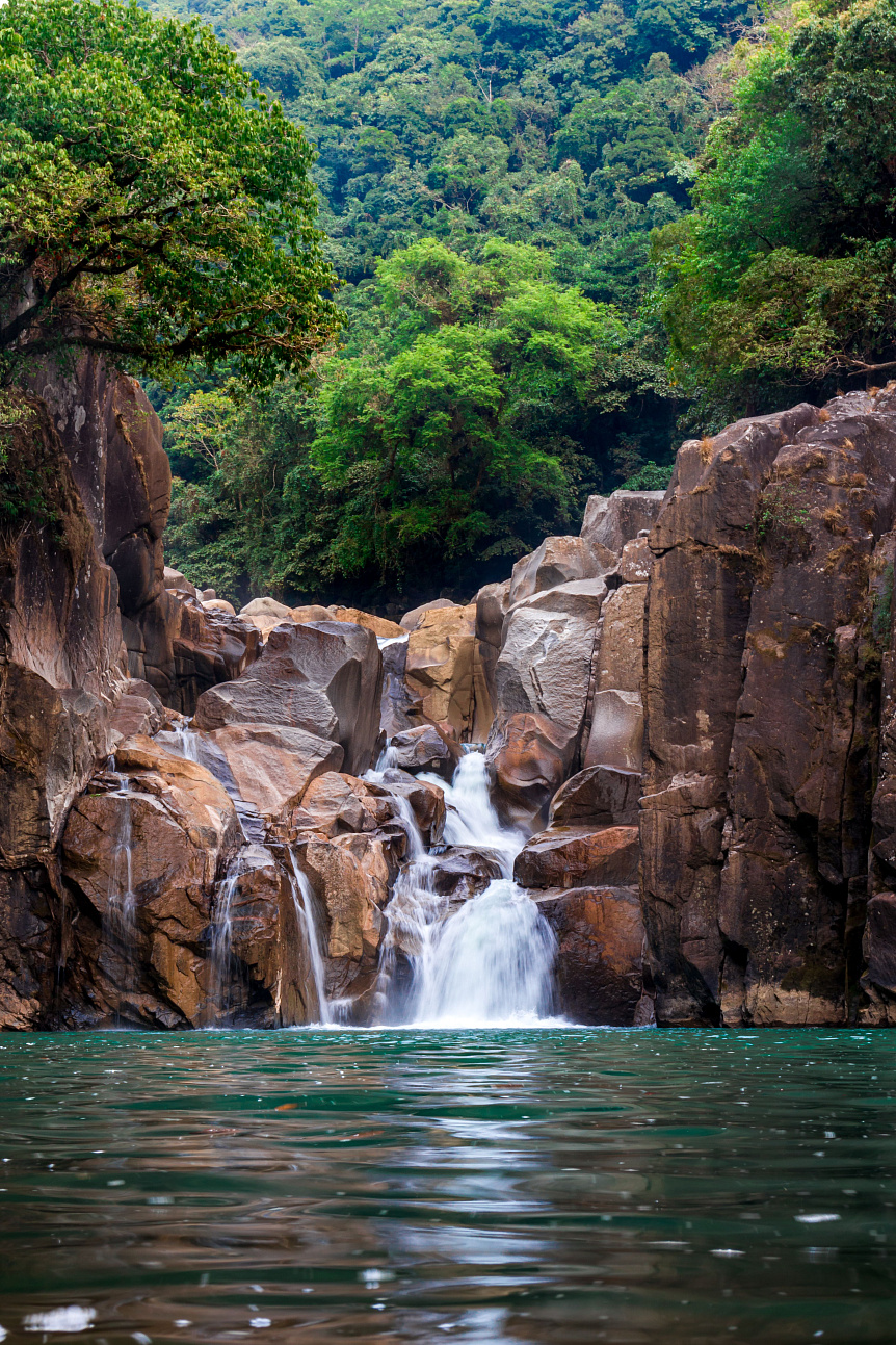 Crystal clear mountain stream flowing over smooth stones symbolizing the purity and divine nature of Jala