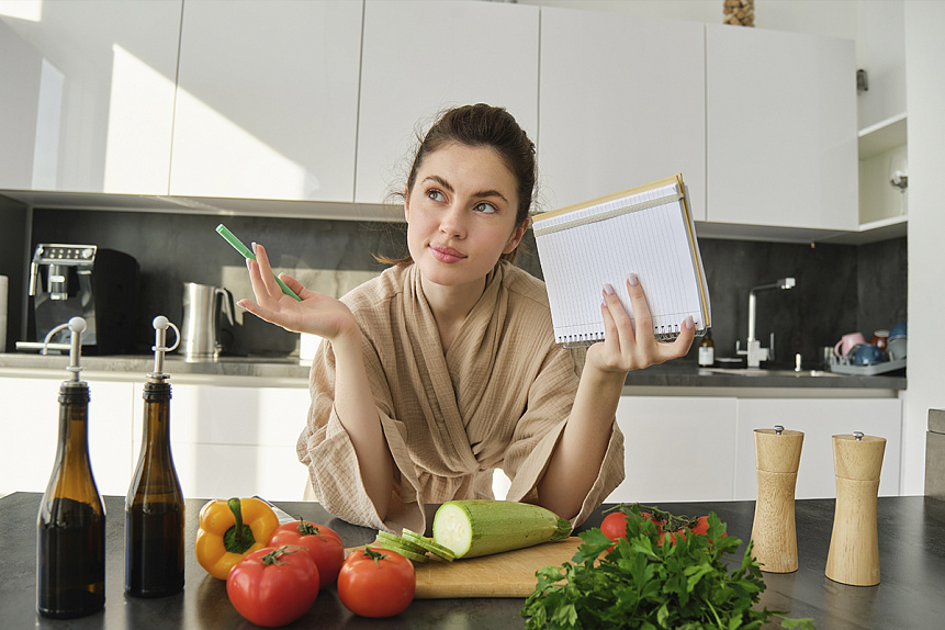 Photo of a woman planning a diet with fresh vegetables reflecting harmony and mindfulness in Ayurveda