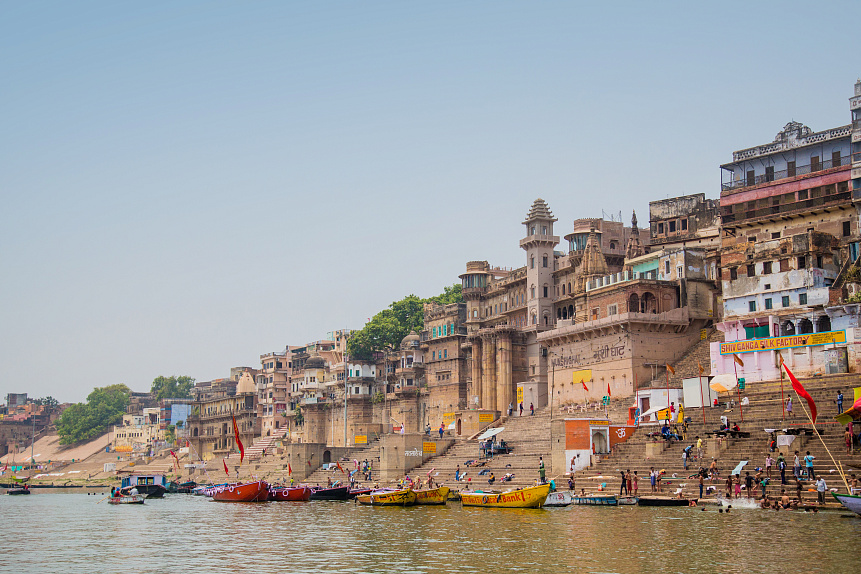 View of the Ganges river banks in India with pilgrims and boats illustrating the connection to the Great Mother