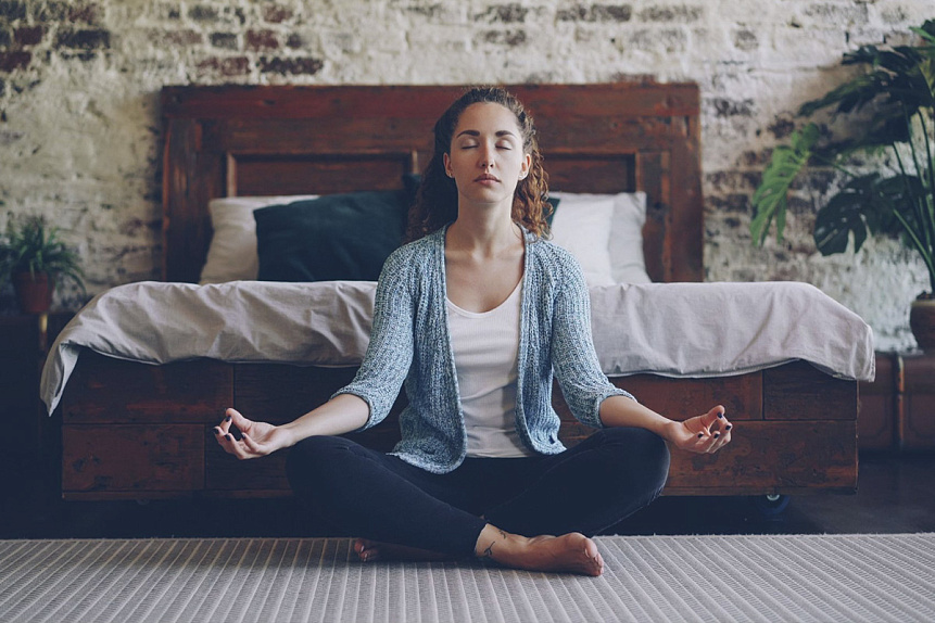 Digital art of a serene person meditating by a window during morning Brahma Muhurta