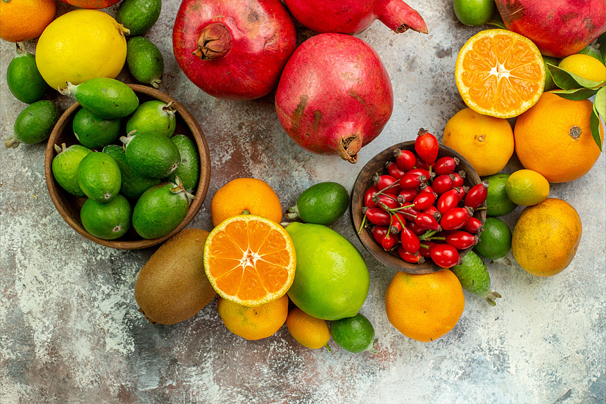 Photo of pomegranates, citrus fruits, and rosehips arranged together, highlighting natural recovery nutrition for amenorrhea.
