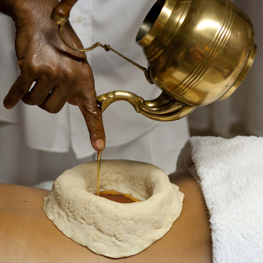 Photo of warm herbal oil pouring into a neck reservoir to relieve tension and cervical osteochondrosis