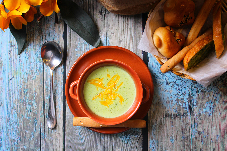 Photo of a creamy zucchini soup in a bowl showcasing a healthy and light summer dinner