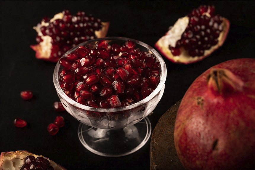 Photograph of pomegranate seeds resting in a bowl highlighting iron rich foods